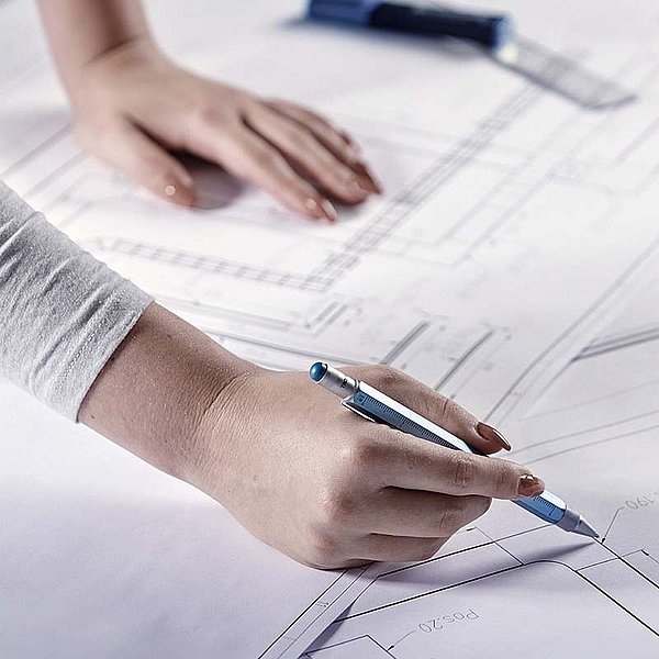 employee checks a drawing of a component assembly